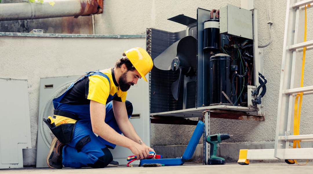 Professional HVAC service provider performing routine preventive maintenance on a HVAC unit.
